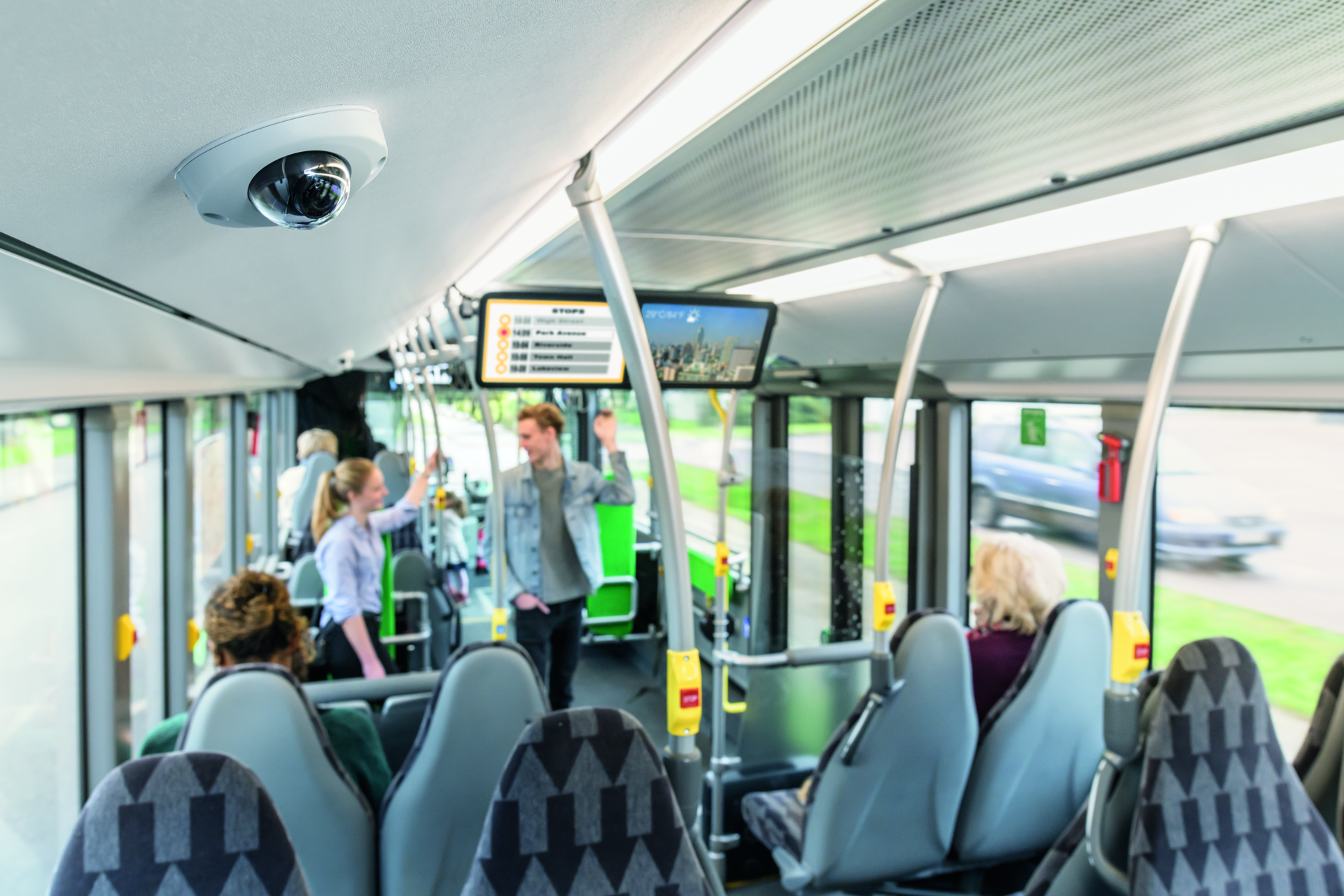 AXIS P39 Series Network Camera installed on a bus ceiling for onboard video surveillance and passenger safety.