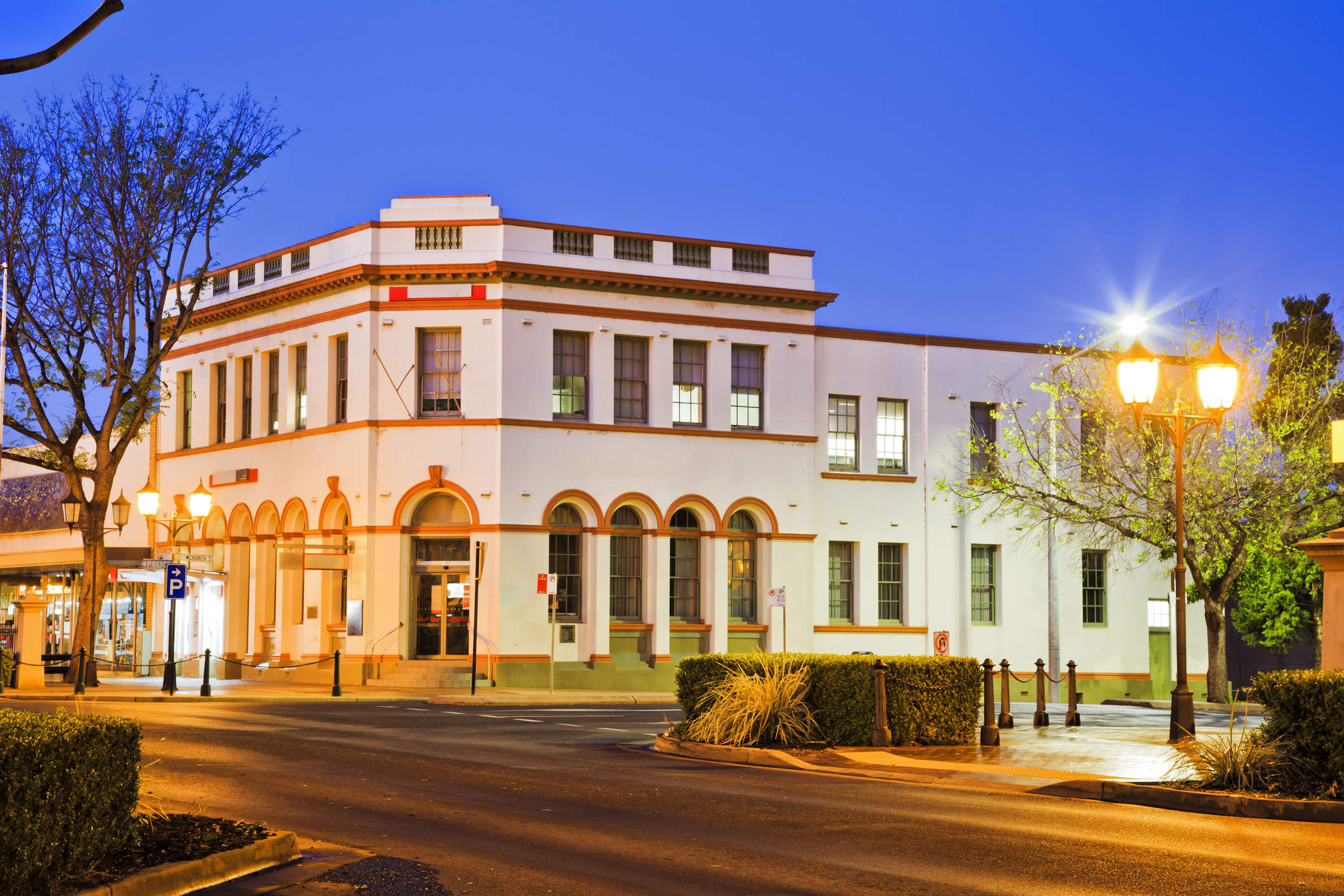 Historic two-story heritage building on a street corner in Dubbo city centre at twilight.