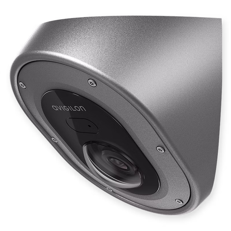 A high-angle, close-up shot of an Avigilon H5A Corner Camera featuring a rugged, stainless steel anti-ligature housing designed for corner mounting in high-security environments.