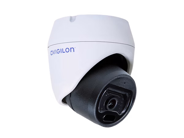 An angled, close-up shot of an Avigilon H5M outdoor dome security camera with a white housing and black lens assembly against a white background.