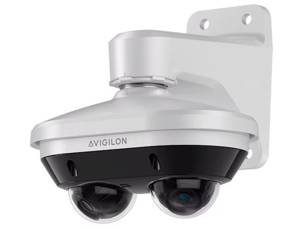 A white Avigilon H6A Dual Head Camera mounted on a white wall bracket, featuring two adjustable hemispherical lens modules for multi-directional surveillance.