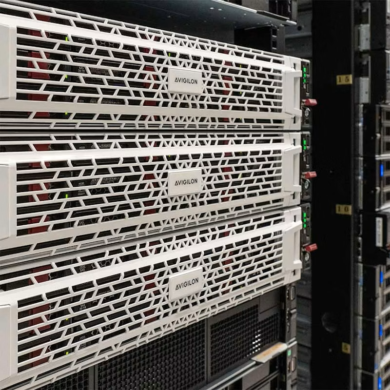 Three Avigilon Network Video Recorder servers stacked vertically in a server rack, characterized by their distinctive white, geometrically patterned front bezels.