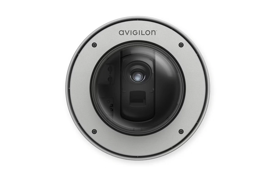 Underside view of a silver Avigilon H5A PTZ dome security camera showing the lens behind a clear protective bubble and the brand logo on the metal housing.