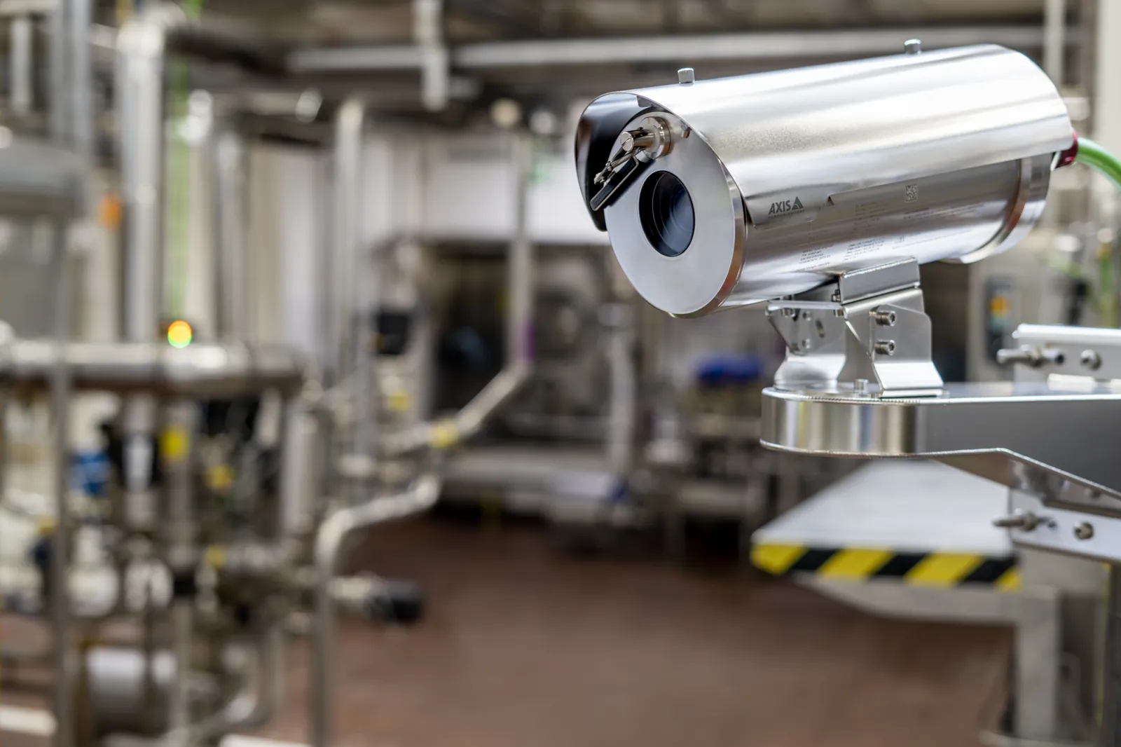 Explosion-protected camera mounted above a stainless steel processing line