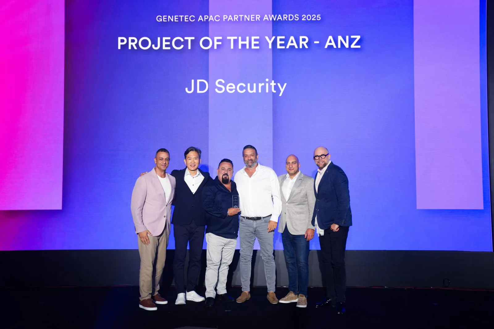 JD Security team accepting the Genetec Project of the Year ANZ award on stage at the 2025 APAC Partner Awards.